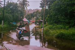 Local tradesman negotiating a flooded road on Tioman Islan